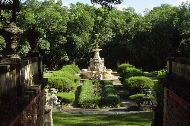 Formal garden with shrubs trees and a fountain