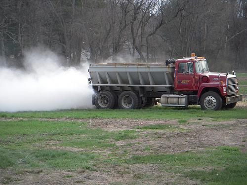 Truck adding lime to a field
