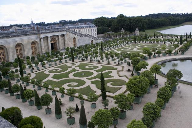 Versailles formal garden with shrubs fountains and a palace in the background
